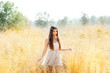 Asian indian woman walking in golden dried field Asian indian woman walking in golden dried field