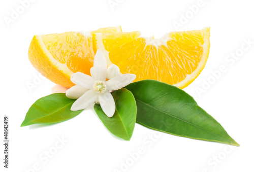 Photo: Orange with a flower and leaves Orange with a flower and leaves