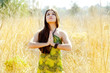 Details der Fotografie Asian indian woman praying hands  in golden field