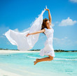Photo: Beautiful Girl With White Scarf Jumping on The Beach Beautiful Girl With White Scarf Jumping on The Beach