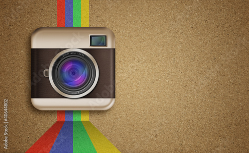 Photo: retro camera icon with rainbow colors on corkboard background retro camera icon with rainbow colors on corkboard background