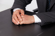 businessman sitting with folded hands
