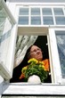 Elderly woman in open window