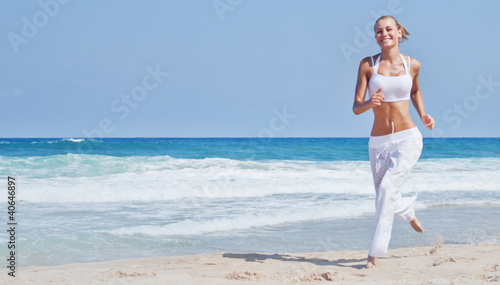 Photo: Healthy woman running on the beach Healthy woman running on the beach