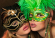 Two beauties posing sexy in lingerie and carnival masks