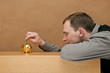 man saves money in his piggy bank