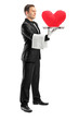 Photo: Waiter holding a tray with a red heart shape on it Waiter holding a tray with a red heart shape on it