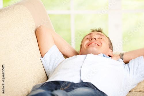 Photo: Man relaxing on sofa Man relaxing on sofa