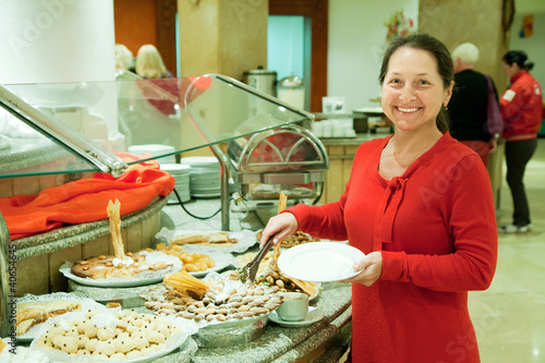 Photo: Woman takes fresh pastry Woman takes fresh pastry