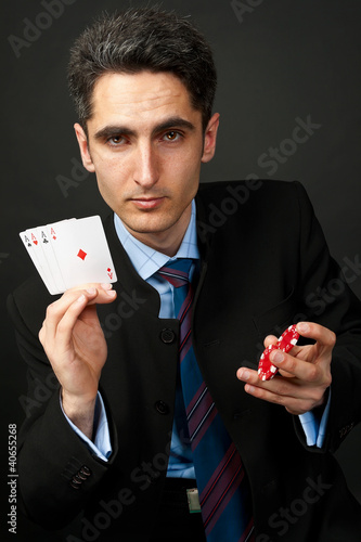 Photo: Gambler with cards and chips. Gambler with cards and chips.