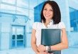 Portrait of happy smiling business woman with folder