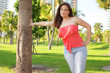 Woman leaning on a tree