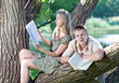 Young guy and the girl prepare for lessons, examination in park Young guy and the girl prepare for lessons, examination in park