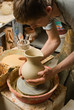 hands of a potter, creating an earthen jar of white clay hands of a potter, creating an earthen jar of white clay