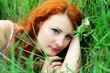 Girl portrait, lying in grass field.