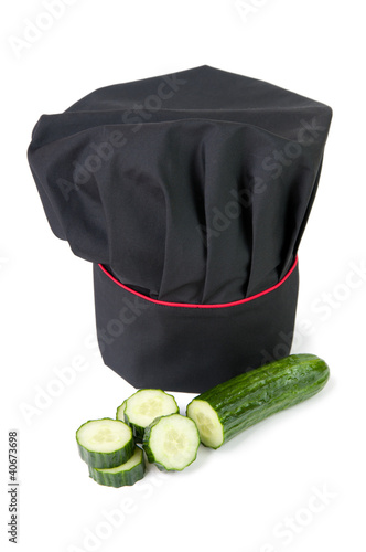 Photo: Fresh cucumber and chef's toque, white background Fresh cucumber and chef's toque, white background