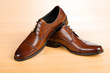 Brown shoes on wooden table Brown shoes on wooden table