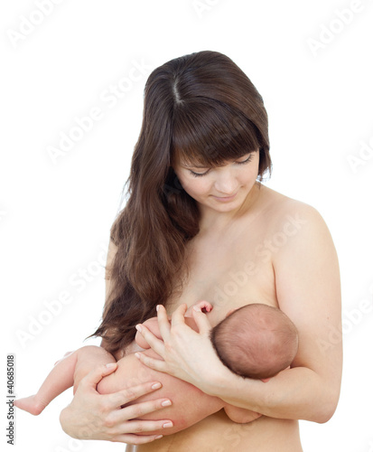 Photo: young mother breast feeding her small newborn baby isolated on w young mother breast feeding her small newborn baby isolated on w