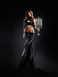 Fashion shoot of a woman in a long dress holding candles