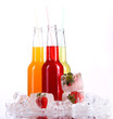 Bottles with colorful cocktail and ice