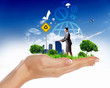 Human hand holding a green landscape