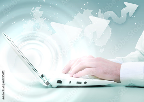 Photo: Laptop against technology background Laptop against technology background