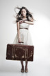 Photo: beautiful girl with long developing hair and suitcase beautiful girl with long developing hair and suitcase