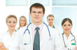 A team of young and smart Caucasian doctors in white A team of young and smart Caucasian doctors in white