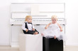 boy and girl in a suit sitting in a concert interior boy and girl in a suit sitting in a concert interior