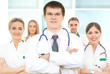 A team of young and smart Caucasian doctors in white A team of young and smart Caucasian doctors in white