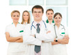 A team of young and smart Caucasian doctors in white
