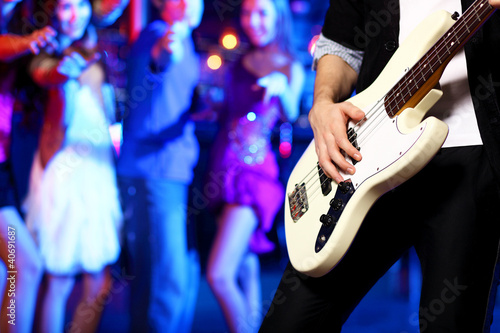 Photo: Young guitar player performing in night club Young guitar player performing in night club