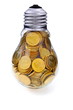 Traditional glass bulb with many golden coins Traditional glass bulb with many golden coins