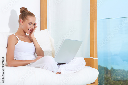 Photo: Shocked woman laughing with laptop Shocked woman laughing with laptop