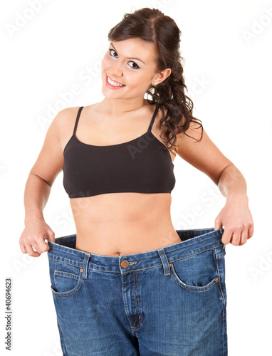 Photo: young woman showing how much weight she lost young woman showing how much weight she lost