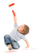 happy young boy painting over white
