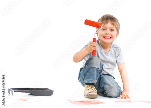 Photo: happy young boy painting over white happy young boy painting over white