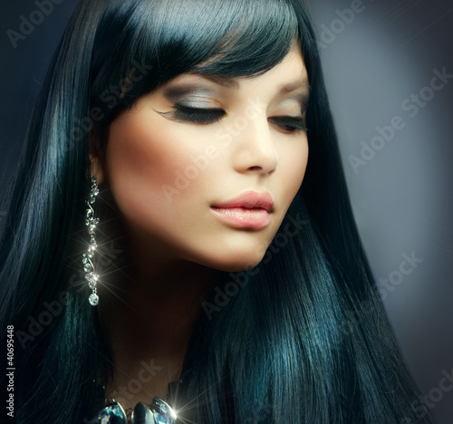 Photo: Beautiful Brunette Girl. Healthy Long Hair and Holiday Makeup Beautiful Brunette Girl. Healthy Long Hair and Holiday Makeup