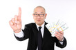 Asian man in a suit with bundles of cash.