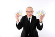 Asian man in a suit with bundles of cash.