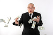 Businessman losing bundles of money.