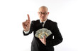 Asian man in a suit with bundles of cash.