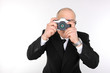 Man in suit with a retro film SLR camera.