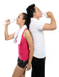 man and woman drinking water after fitness
