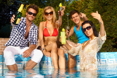 Photo: Cheerful people by swimming pool Cheerful people by swimming pool