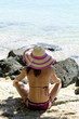woman sitting on beach wearing hat woman sitting on beach wearing hat