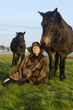 Photo: An outdoor woman with her horses. An outdoor woman with her horses.