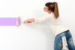 Photo: Cute girl painting the wall. Cute girl painting the wall.