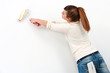 Photo: Young female painter painting. Young female painter painting.