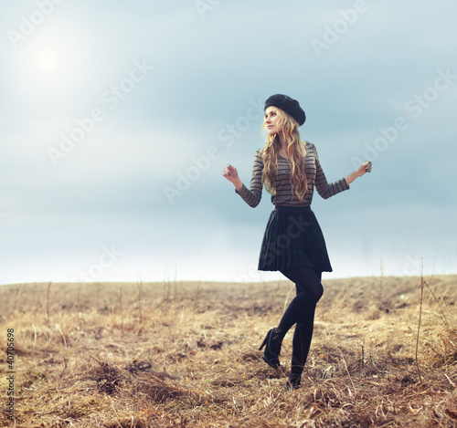 Photo: a beautiful young girl walks in the park a beautiful young girl walks in the park